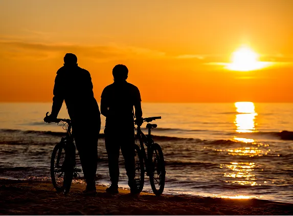 Couple biking at sunset