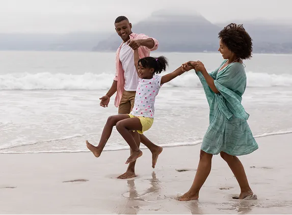 family having fun at beach